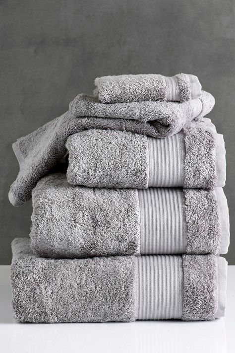 Our Egyptian towel range is produced with 100 percent extra long staple certified Egyptian cotton pile, giving the towels an extra soft finish and high absorbency levels. Their 600gsm thickness makes these towels feel plump and fluffy and they are also designed to retain their colour for up to 50 washes, meaning they will look new for longer. Available in a rainbow of colours, choose from over thirty different shades to compliment your bathroom's style. Machine washable. Pile 100% Egyptian Cotto Egyptian Cotton Towels, Bathroom Themes, Large Baths, Gray Towels, Striped Towels, Face Cloth, Bath Sheets, Egyptian Cotton, Bathroom Towels