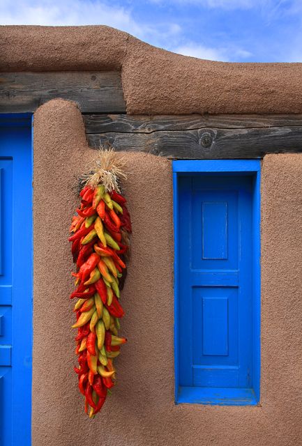 Chile ristras are common decorations around doors and windows on homes in New Mexico  #KlausPriebe Chile Ristra, Southwestern Landscape, New Mexico Style, New Mexico Homes, Blue Doors, Taos New Mexico, Mexico Style, Adobe House, Santa Fe Style