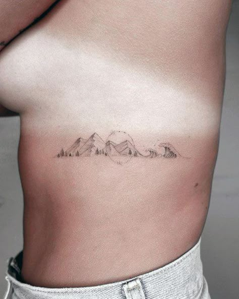 Rib Tattoo Mountain, Rib Cage Mountain Tattoo, Tiny Tattoos Nature, Rib Mountain Tattoo, Moutain Tattoos For Women, Mountain Tattoo Ribs, Mountain Rib Tattoo, Granola Tattoos, Mountain And Ocean Tattoo