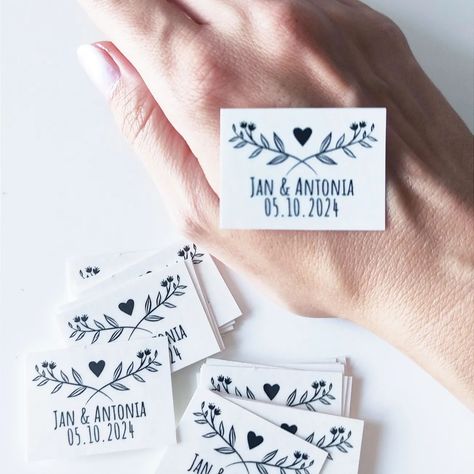 The Ultimate Wedding Souvenir: Temporary Tattoos for Guests 💕 Recently, I had an intriguing thought: wouldn't it be amazing if wedding couples could offer their guests temporary tattoos featuring the couple's names and wedding date? 💒 Imagine the fun and excitement this would bring to the celebration! It's a unique and memorable way for guests to feel even more connected to the special day. Thankfully, these tattoos are washable, so everyone can enjoy the moment without any long-term commitm... Wedding Photos With Guests, Wedding Temporary Tattoos, Temporary Tattoo Paper, Elegant Ballroom, Memories Photo, Portrait Tattoos, Garden Ceremony, Wedding Souvenir, Tattoo Paper