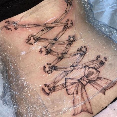 Y2k Tattoos Ideas, Lace Up Back Tattoo, Lace Corset Tattoo, Corset Tattoo Design, Corset Ribbon Tattoo, Corset Tattoo Back, Corset Piercing Tattoo, Corset Bow Tattoo, Corset Tattoo Leg