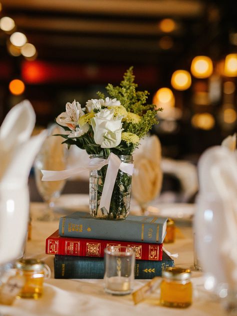 Vintage Books Wedding Centerpieces Book Themed Wedding Centerpieces, Vintage Grad Party, Book Themed Graduation Party, Centerpieces With Books, Vintage Book Centerpiece, Vintage Graduation Party, Graduation Display, Cheap Wedding Table Centerpieces, Vintage Party Theme