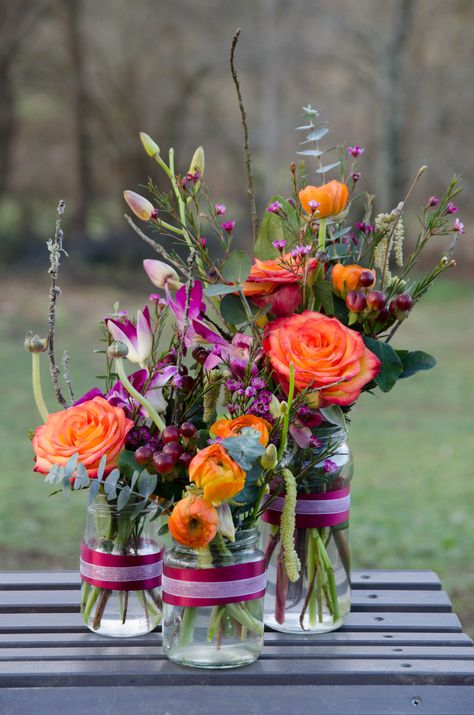 bright jam jars Jam Jar Posies, Colourful Floral Centrepiece, Jam Jar Flower Arrangements, Jam Jar Wedding Flowers, Retirement Flowers, Jam Jars Wedding, Bridal Shower Themes Rustic, Jam Jar Wedding, Jar Arrangements