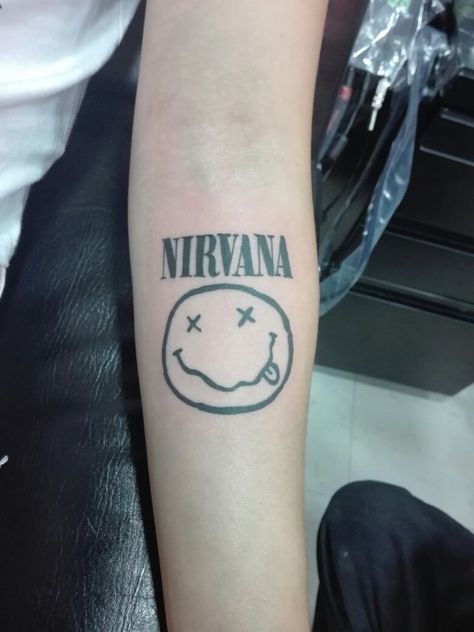 Nirvana 90s Band Tattoos, Nirvana Word Tattoo, Tattoo Ideas Nirvana, Nirvana Nevermind Tattoo, Small Nirvana Tattoo, Nirvana Quote Tattoo, Nirvana Symbol, Trippy Smiley Face Tattoo, Nirvana Logo Tattoo