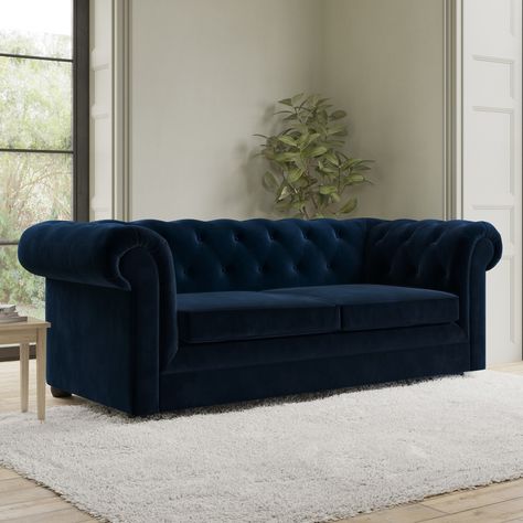 All about meAdd a touch of class to any room in your home with this traditional Bronte pull out sofa bed. It has classic Chesterfield features such as luxurious scrolled arms button tufted back and arms and turned wooden feet. Velvet upholstery and comfortable spongy foam-filled cushions make it cosy to sit on. Plus it's quick and easy to transform into a sofa bed and even comes with a built-in mattress giving guests a restful night’s sleep. It has been built to last with its durable woode Sofa Cum Bed Guest Rooms, Royal Blue Sofa, Navy Velvet Sofa, Wooden Frame Sofa, Chesterfield Sofa Bed, Button Sofa, Velvet Chesterfield, Navy Blue Sofa, Law Library