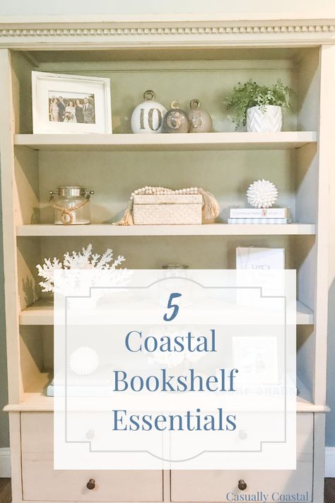 Five Coastal Bookshelf Essentials Coastal Bookcase Decorating Ideas, Beach Shelving Decor, Coastal Entertainment Center Decor, Coastal Bookshelf Decor Living Room, Beach Themed Bookshelves, Coastal Built Ins Bookshelves, Coastal Living Room Built Ins, Coastal Floating Shelves Decor, Beach House Shelf Decor