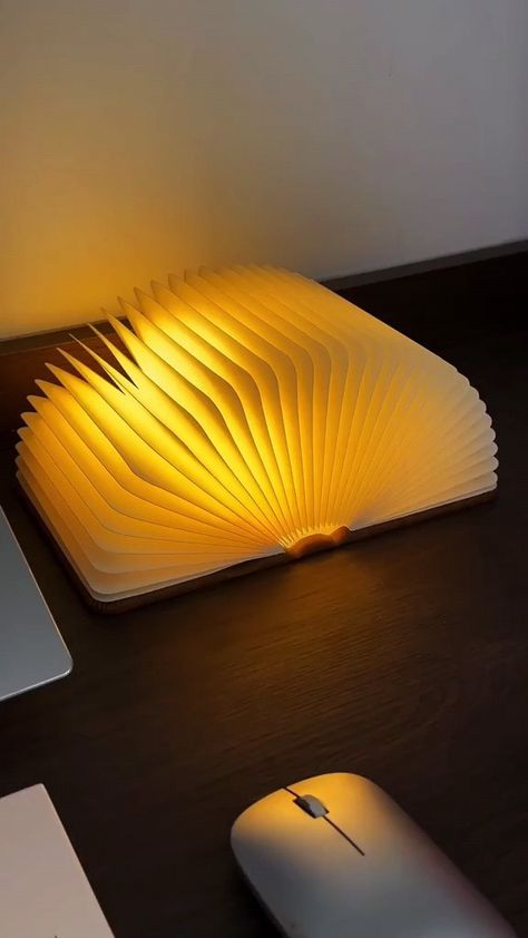 Perfect for book lovers, this folding wooden book light combines style and function. Shaped like a book, it opens to reveal a warm LED light, ideal for creating a cozy reading nook. Compact, portable, and rechargeable, this wooden book lamp is a unique decor piece for any room or bookshelf. Great as a gift for readers, students, or anyone who loves ambient lighting. #BookLovers #FoldingBookLight #WoodenBookLamp #ReadingLight #UniqueLighting #BookDecor #GiftsForReaders Book Lamps, Apartment Vision Board, Book Birthday Parties, Book Lamp, Small Room Design Bedroom, Book Birthday, Barber Shop Decor, Book Light, Aesthetic Diy