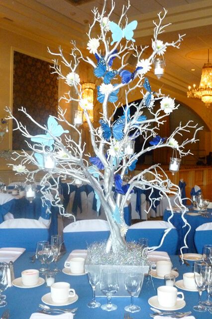 Silver Tree Centerpiece Silver Tree Centerpiece with Blue Butterflies & Hanging Tea Lights Butterfly Quince Theme, Butterfly Quinceanera Theme, Hanging Tea Lights, Butterfly Centerpieces, Sweet 15 Party Ideas Quinceanera, Sweet 15 Party Ideas, Tree Centerpiece, Centerpieces Party, Quince Decorations