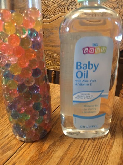 How To Make A Glitter Water Bead Sensory Bottle - New Mom at 40 Sensory Bottles Water Beads, Orbeez Sensory Bottle, Sensory Bottle With Water Beads, Water Beads Sensory Bottle, Water Bead Sensory Bags, Water Bead Sensory Bottle, Water Beads Ideas, Orbeez Ideas, Sensory Bottle Ideas