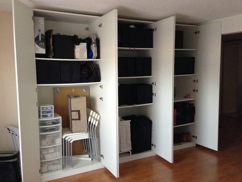 IKEA Pax storage impressively organized -- Compact, Transforming Apartment on a Budget - LifeEdited Pax Utility Closet, Pax Garage Storage, Ikea Pax Garage, Luggage Storage Ideas, Ikea Sliding Wardrobes, Pax Bedroom, Pax Storage, Ikea Closet Storage, Ikea Wardrobe Closet