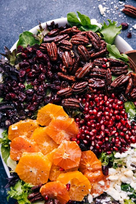 This delicious Winter Salad is a hit of brightness during even the coldest of weather! Combine your favorite winter fruit (pears, apples, or oranges) with dried cranberries, pomegranate, and feta (or goat) cheese. Add some pumpkin seeds or some irresistible maple-cinnamon pecans on top and drizzle on the absolute best creamy maple vinaigrette! Recipe via chelseasmessyapron #dinner #quick #easy #simple #healthy #best #familyfriendly #kidfriendly #feta #pecans #winter #salad Christmas Salad Half Baked Harvest, Apple Winter Salad, Winter Glow Salad, Salad With Goat Cheese And Cranberries, Salad With Pine Nuts Healthy, Yellow Beets Salad, Fancy Side Salad, January Foods In Season, Winter Fruit Recipes