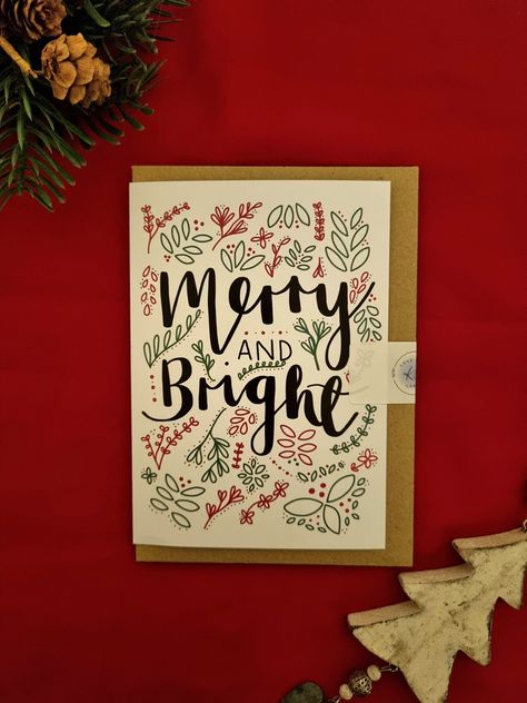 A 'Merry and Bright' Christmas card, featuring hand drawn calligraphy writing and festive doodles.  Designed by Kate and printed in the UK on luxury 350gsm recyclable card with a kraft envelope. Blank inside for your own message. Put a smile on someone's face this festive season with a handmade eco friendly Christmas card! Material: card, envelope and packaging are all plastic free and recyclable.  Size: A6  Postage: 2nd Class Royal Mail (2-3 working days) OR upgrade to 1st Class for £1 Christmas Calligraphy Cards, Calligraphy Christmas Cards, Hand Drawn Christmas Cards, Hand Drawn Calligraphy, Christmas Calligraphy, Calligraphy Writing, Calligraphy Cards, Eco Friendly Christmas, Handmade Christmas Card