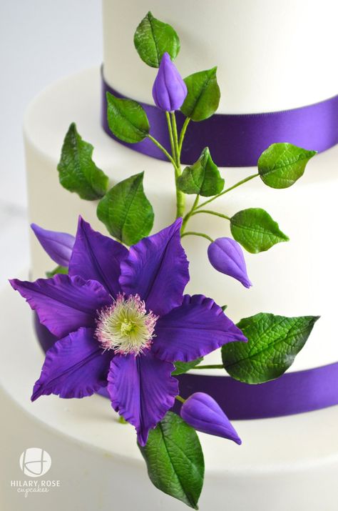 Purple Gum Paste Clematis And Buds Dusted With Empress Purple To Match The Ribbon On 3 Tier Wedding Cake Purple gum paste Clematis and buds... Wedding Cake Purple, 3 Tier Wedding Cake, Cake Purple, Sugar Paste Flowers, Sugar Flowers Tutorial, Purple Clematis, Round Wedding Cakes, Purple Wedding Cakes, Gumpaste Flowers