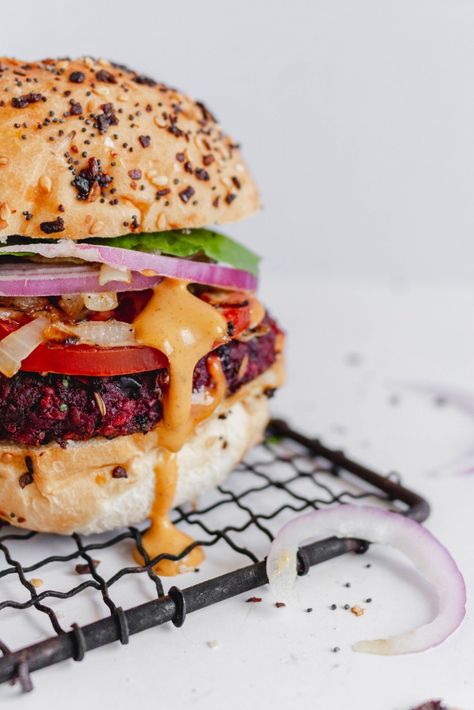 Vibrant black bean beet burger on a hamburger bun with lettuce, onion, tomato, and dripping with chipotle aioli sauce on a white backdrop. Beet Burger Recipe, Sweet Potato Pizza Crust, Beet Burger, Black Bean Burger, Healthy Snacks To Make, Veggie Burgers Recipe, Bean Burgers, Mushroom Burger, Black Bean Burgers