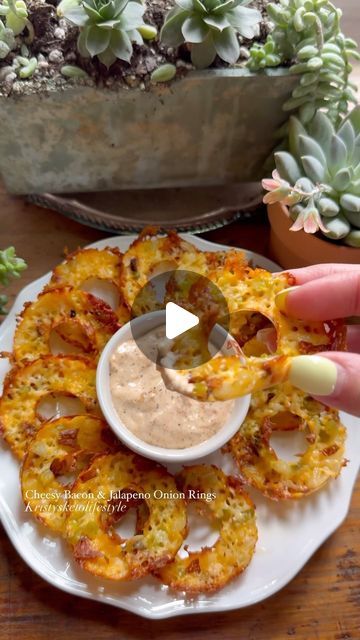 Kristy Hawk on Instagram: "Cheesy Onion Rings These cheesy bacon & jalapeño onion rings are a super easy and yummy snack! They’re especially good dipped in my Copycat Bloomin’ Onion sauce which can also be found in my Kristy’s Keto Recipes Cookbook 👉🏼www.Kristysketolifestyle.com/shop  RECIPE - Makes 12 onion rings  INGREDIENTS: 2 cups shredded Colby Jack cheese  2 onion slices, diced 8 jalapeño rings 3 pieces of bacon, crumbled   DIRECTIONS: 1. Preheat oven to 375 degrees Fahrenheit.  2. Place half of the shredded cheese in each ring of a silicone donut pan.  3. Add some of the bacon, jalapeños and onions to each one.  4. Top with remaining cheese and bake for 20 minutes or until the edges start to brown.  *Let them cool down a bit before transferring to a paper towel to drain up the exc Cheesy Onion Bacon Rings, Keto Cheese Onion Rings, Keto Onion Rings Baked, Keto Cheese Onion Rings Baked, Cheesy Onion Rings, Cheese Onion Rings, Daily Yum Air Fryer Onion Rings, Blooming Onion Sauce, Baked Onion Rings