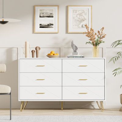 White dresser for bedroom. Features: - 6 Deep drawers: Ample space for daily storage - Anti-tipping device: Prevent your kids or pets from the incident - Gold handles: Create a clean and spacious look in your bedroom or living room - Wide tabletop: Offers a decent place for your daily stuff Specifications: - Color: White - Material: Engineered wood - Overall dimension: 47.2" L x 15.7" D x 29.5" H - Weight capacity: 35 lbs in each drawer Package includes: - 1 x 6 Drawer dresser - 1 x Instructions White And Gold Dresser And Nightstand, White And Gold Bedroom Dressers, White Bedroom Gold Accents, Gold And White Bedroom Decor, White And Gold Room Decor, White Dresser With Gold, White And Gold Room, Gold And White Bedroom, White And Gold Bedroom