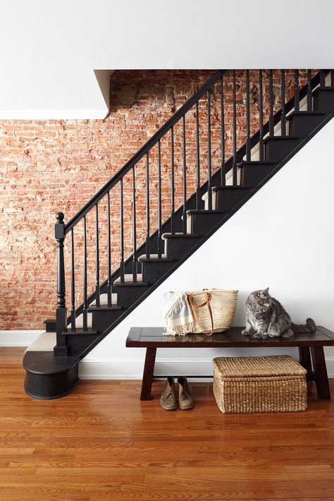 Stairwell with exposed brick wall. Black painted treads, risers, and railing. Exposed Brick Bedroom Wall, Exposed Brick Interior Wall, Brick Staircase Wall, Exposed Brick Stairwell, Staircase Brick Wall, Brick Wall Stairs, Exposed Brick Staircase, Brick Stairwell Interior, Exposed Stairs In Living Room