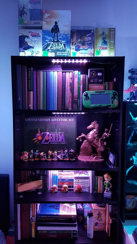 My Zelda Collection. Since everyone's posting them! Gamer Display Ideas, Zelda Collection Display, Zelda Room Aesthetic, Legend Of Zelda Room Ideas, Nintendo Gaming Room, Video Game Collection Display, Zelda Home Decor, Gamer Bookshelf, Video Game Organization Ideas