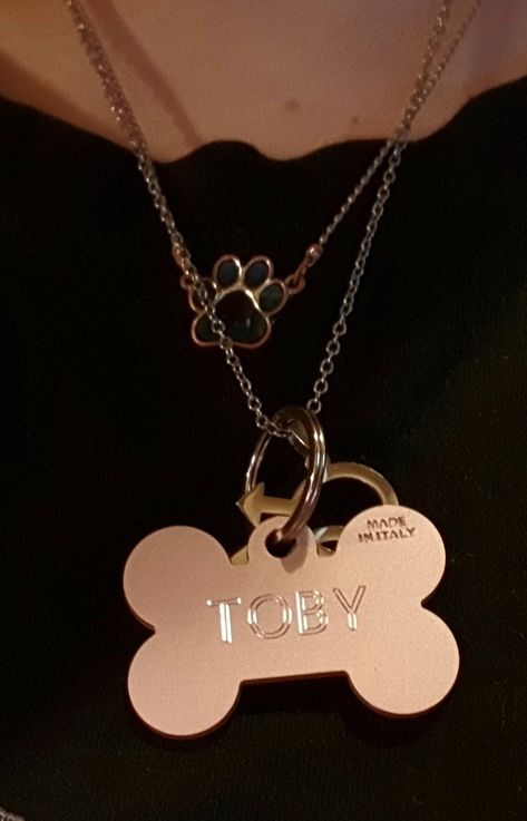 A necklace with a mood ring style paw pendant and another necklace with a custom engraved bone shaped dog tag that reads "Toby" as well as a homosexual man pendant on it Dog Bone Necklace, Dog Tag Necklace Aesthetic, Therian Jewelry, Dog Boy Aesthetic, Therian Necklace, Therian Accessories, Puppyboy Aesthetic, Dog Therian, Dogtag Necklace