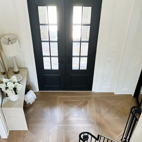 THIRD & EVERGREEN  •  Interior Design on Instagram: "🤍 First Impressions 🤍

A foyers design should set the tone for the personality of your home.

Custom inlay flooring, judges paneling and a sleek new staircase elevated this once traditional foyer to an elegant entry. 

@thirdandevergreen 

#interior #interiordesign #foyer #foyerdesign #stairs #custom #customfloors #atlantadesigner #residential #residentialdesign #architecture" Wood Floor Foyer Design, Foyer Wood Floor Design, Marble Wood Entryway Floor, Entryway Wood Floor Pattern, Tile Inlay Wood Floor Entryway, Judges Paneling, Traditional Foyer, Inlay Flooring, Foyer Flooring