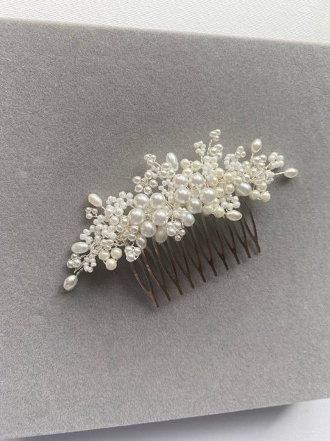 An intricate, handmade bridal comb. Made with tiny seed pearls, crystal beads and freshwater pearls. This unique design is light and flexible and will work with most hairstyles- particularly a bun or worn to the side of the head with loose waves.  4.5 inches in length SHIPPING AND PACKAGING- All Ivy and Pearl hairpieces come packaged in a beautiful gift box. I offer exchanges. Please see 'Shop Policies' section for further information and exceptions. All hairpieces are especially handmade for ea Pearl Hairpiece, Pearl Bridal Comb, Pearl Comb, Hair Accessories Bridal, Pearl Hair Combs, Hair Bobbles, Bridal Comb, Pearl Hair Pins, Hair Comb Wedding