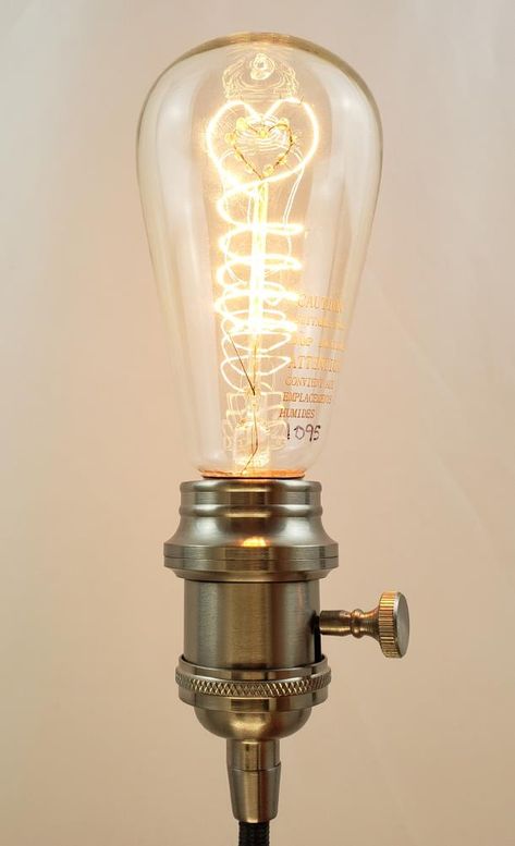 Inspired by turn of the century industrial lighting by Thomas Edison. Features a glass and brass bulb with hand-woven tungsten filaments in a vertical, helical formation. 40W and an estimated 3000 hours of use. LIFEGARD Antique Filament Bulbs 60-Watt ST19 Vintage Decorative Incandescent Light Bulb | L104-019-CLEAR ST64 Vintage Light Bulbs, Decorative Light Bulbs, Incandescent Light Bulb, Incandescent Light, Old Lights, Thomas Edison, Turn Of The Century, Filament Bulb, Incandescent Lighting