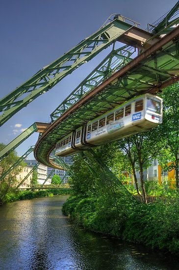 Combining green spaces with public transportation could help Louisville create more parks and places for animals to be. In this pin, a train is raised above a park enough to not damage the plants and animals around it. Wuppertal Germany, Victorian Greenhouses, Eco City, North Rhine Westphalia, Green Architecture, Green City, Futuristic City, Future City, River Valley