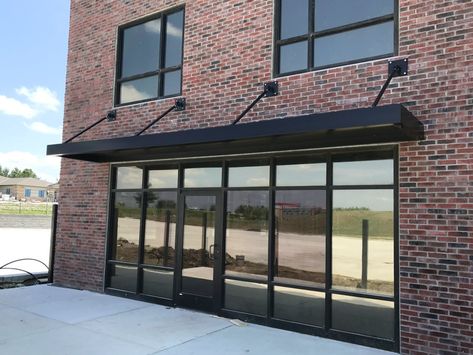 black metal awning Black Metal Awning, Metal Awnings For Windows, Awning Over Door, Metal Awnings, House Awnings, Aluminum Awnings, Metal Awning, Townhouse Garden, Column Lighting