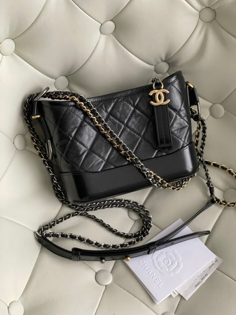 Chanel 22k Bag, Chanel Lamb Skin Top Handle Bag, Luxury Black Satchel With Logo Hardware, Luxury Miu Miu Shoulder Bag For Travel, Luxury Black Bags With Logo Charm, Luxury Shoulder Bag With Cc Turnlock For Everyday, Luxury Everyday Shoulder Bag With Lock, Luxury Modern Bag With Logo Charm, Luxury Black Everyday Bags