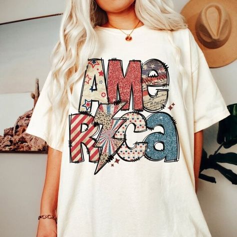 4th of July America White Shirt, Sparkly America Shirt, Independence Day T-shirt Cheap Trendy T-shirt For Independence Day, Cheap Printed T-shirt For 4th Of July, Cheap Fun Style Independence Day T-shirt, American Retro Graphic Print Summer Tops, Multicolor Cotton Top For 4th Of July, Relaxed Fit Graphic Print Americana Tops, Relaxed Fit Americana Tops With Graphic Print, Labor Day Americana Top With Graphic Print, Summer American Retro Letter Print Tops