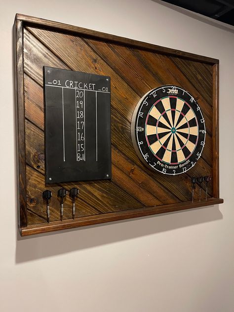 A great addition to your Game Room, Garage, Patio or Man Cave, this Dart Backboard is 39.75 X 30H.  It is custom made in a variety of stains and adds style and decor to your game. Hanging hardware included. **Optional Score Board** **Backboard has pre drilled holes for darts** Dart Board and darts not included Dimensions 40W x 30H x 4D RETURNS: Are welcome for this product but the buyer must pay for any shipping cost that occur in this transaction. Dart Backboard, Dart Board Backboard, Darts Board, Dart Board Wall, Small Man Cave, Board Game Room, Small Game Rooms, Pool Table Room, Home Bar Rooms