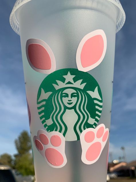 Hop into Easter with a Custom Starbucks Cold Cup. Show your personality while enjoying your favorite cold drink.  Venti Starbucks Reusable Cold Cup with lid and straw. , BPA free, 24 oz.  Personalize with your name.  Perfect for Easter baskets or just a little something to spoil yourself with.  Cups are made with permanent vinyl. Please hand wash in cool water only and avoid scrubbing or soaking the cup. Bulk orders will take longer to process than smaller orders. Local purchases can use coupon Easter Starbucks Cups, Disney Savings, Vacation Fund, Money Planner, Cup With Lid And Straw, Money Envelopes, Custom Cup, Cricut Craft, Cup With Lid