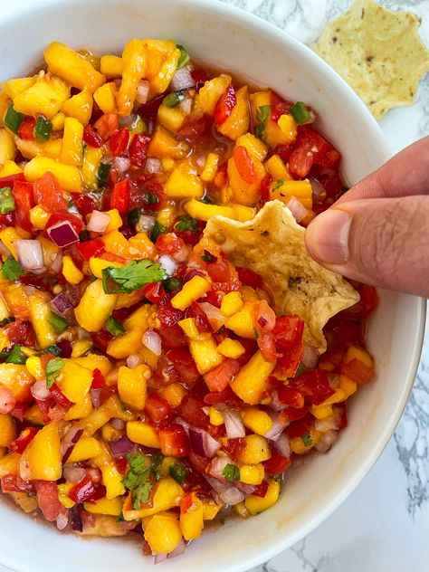 This Peach Mango Salsa is so delicious on top of fish tacos, regular tacos, any Mexican inspired cuisine, or just alone with chips Peach Mango Salsa Recipe For Canning, Fruit Salsa For Tacos, Sweet Mango Salsa, Peach And Mango Salsa, Salsa Recipe Mango, Apricot Salsa Recipes, Pineapple Peach Salsa, Mango Salsa Salad, Peach Mango Salsa Recipe