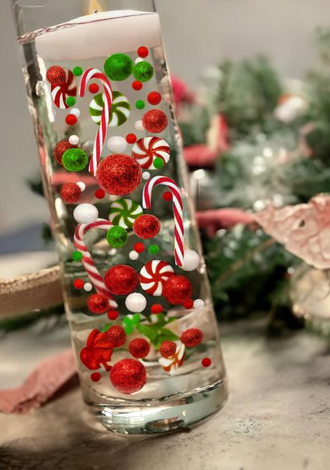 PRICES MAY VARY. Package includes: 7000 * clear water gel beads, 15 * red pearl, 15 * green pearl, 15 white peral, 7 * red acrylic Lollipops, 7 * green acrylic Lollipops 3 * red Candy Canes, 3 * green Candy Canes, These christams vase fillers are enough for you to fill at least 10 vases and create attractive floating candle centerpieces for your special day!. Note: Candles and vase are not included. Just put the water gel bead in water and absorb enough water to make it expand. The water jelly b Water Beads Centerpiece Christmas, Red And White Christmas Centerpieces, Floating Christmas Candles, Christmas Vase Filler Ideas, Christmas Vase Filler, Water Beads Centerpiece, Beer Bottle Centerpieces, Cylinder Vase Centerpiece, Grinchmas Party