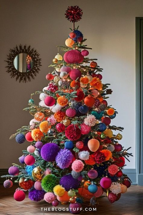 Colorful pompom Christmas tree decorated with bold ornaments in various shapes and textures. Cool Christmas Trees Creative, Tree Theme Ideas Christmas, Craft Themed Christmas Tree, Fun Colorful Christmas Trees, Kid Tree Christmas, Multi Color Tree Decorations, Pompom Ornaments Christmas Tree, Colorful Christmas Tree With Ribbon, Rainbow Tree Decorations