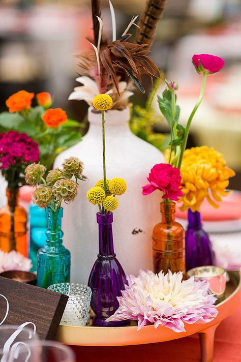 Colorful wedding centerpiece ideas. Colored Vases Centerpiece, Colored Glass Wedding Table Decor, Fiesta Wedding Centerpieces, Colorful Glass Centerpieces, Funky Wedding Centerpieces, Wedding Centerpieces Not Flowers, Nature Wedding Centerpieces, Colorful Centerpieces Wedding, Flower Arrangements Colorful