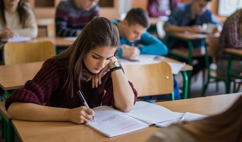 A high school student writes in a notebook in class College Classroom, Writing Conferences, Topic Sentences, Station Activities, Cell Phone Service, Education Organization, High School Education, Education Kindergarten, Math Videos