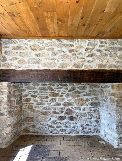 250-year-old stone fireplace makeover using lime mortar to repoint stones.   #stonefireplace #limemortar #oldbuildings #historicconstructiontechniques #historicconstruction #repointing #woodmantel Mortar Washed Stone Fireplace, White Mortar Stone Fireplace, Grouting Stone Fireplace, Heavy Mortar Stone Fireplace, Over Grouted Rock Fireplace, Mortar Wash Stone Fireplace, Update Stone Fireplace, Over Grout Exterior Stone, Lime Stone Wall