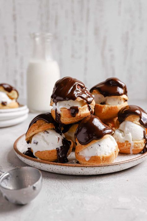 A white plate with a tower of profiteroles topped with chocolate and an ice cream scoop in the front. Profiteroles Recipe, Brown Eyed Baker, Choux Pastry, White Plate, Cream Puffs, Chocolate Sauce, Eclairs, Pastry Recipes, Best Dessert Recipes