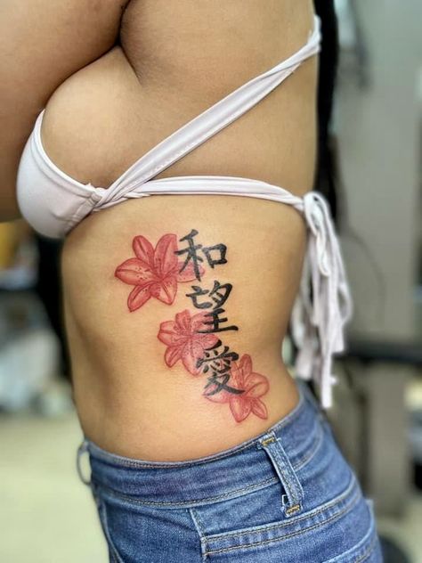 Side Of Ribs Tattoo Women, Baddie Side Tattoos, Red Stomach Tattoos Women, Cherry Blossom Stomach Tattoo, Down The Side Tattoos Women, Flower Side Tattoos Women Ribs, Red Rib Tattoos For Women, Small Asian Tattoos For Women, Cute Waist Tattoos