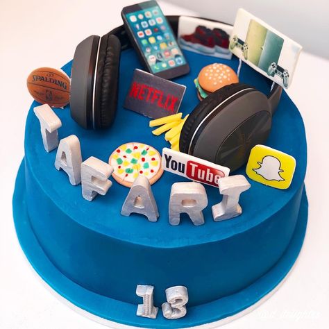 Boys birthday cake 13 year old with all his favourite things to do and eat. Real headphone present added to cake. Electric blue colour 20 Year Old Birthday Cake Boys, Cake Designs For 12 Year Boy, Cake For 12 Year Boy, Birthday Cake For 15 Year Boy, Cake For 11th Birthday Boy, Boys 11th Birthday Cake, 10 Birthday Cake Boy, Birthday Cake 13 Boy, Cake For Teenagers Boys