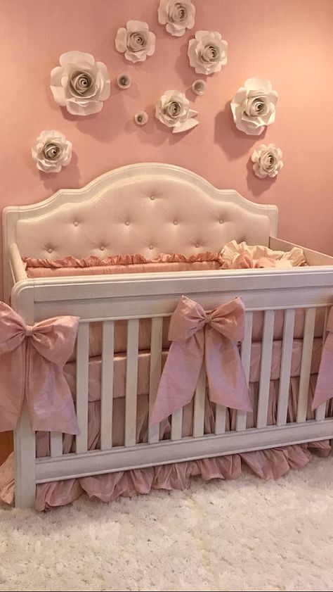 Elegant DIY paper roses and satin bows on a crib with tufted upholstery and dupioni silk baby bedding with ruffles.  Pink baby girl nursery decorating ideas with DIY crafts projects. Pink White Nursery, Pink Crib Nursery, Cute Nursery Ideas Girl, Crib Decoration Ideas, Vintage Crib Bedding, Baby Beds, Crib Ideas, Baby Crib, Pink Nursery Ideas