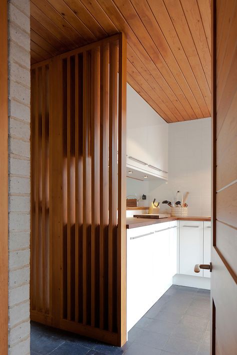 1960s modern kitchen interior with wooden divide Kitchen Screen Divider, Slat Wall In Kitchen, Mcm Slat Wall, Wooden Battens On Wall, Timber Screen Interior, Wooden Screen Divider, Room Divider Kitchen, Slat Divider, Kitchen Screen