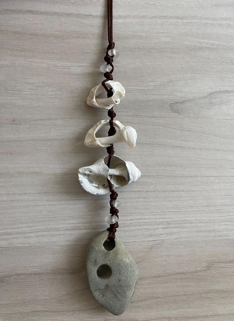 Hag stones are said to have many uses. Protection, Meditation, Astral Travel, Cleansing Rituals, Divination, Connection with the spiritual realm or with ancestors who have passed on, just to name a few.   Hag Stone with Shells and Sea Glass/Recycled Glass Wall Hanging, Holey Stone Wall Hanging, Odin Stone Wall Art, Protection Stone Hag Stone Wall Hanging with shells and sea glass/recycled glass. Hag stone found on Bullard's Beach in Bandon Oregon and the shells were found on Revere Beach in Reve Stone Crafts Diy, Stone Wall Decor, Revere Massachusetts, Protection Meditation, Holey Stone, Revere Beach, Cleansing Rituals, Bandon Oregon, Glass Wall Hanging