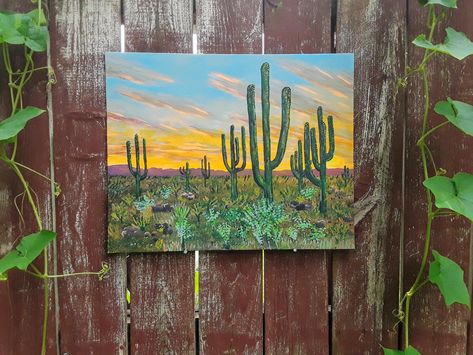 My own acrylic painting of a southwestern desert view with a spectacular bright orange sunset against a blue sky with tall cactus and desert shrubs in the foreground! The official title is "Fire in the Desert Sky" and would make a beautiful addition to your home, it looks great placed over a couch or bed, in the office or even in a professional setting! Painted on a 16x20" canvas board, this piece comes flat and ready for you to frame! The 2nd painting in a series of western landscapes done in t Desert Shrubs, Acrylic Cactus, Cactus Landscape, Desert Pictures, Tall Cactus, Western Landscape, Western Paintings, Orange Sunset, Desert Sky