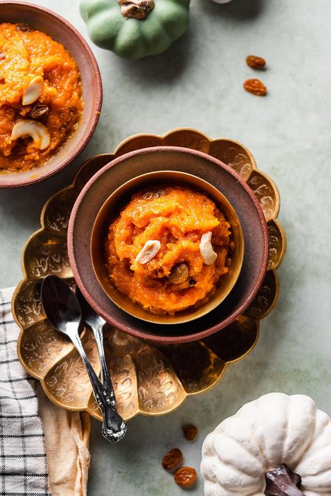 This creamy Pumpkin Halwa, or kaddu ka halwa, is the perfect fall dessert for celebrating Indian festivals. Fresh pumpkin is simmered down into a pudding-like consistency and topped with toasted cashews and golden raisins. It's incredibly rich in flavor and suitable to enjoy for breakfast or a light evening dessert. Unique Fall Desserts, Toasted Cashews, Best Indian Recipes, Leftover Pumpkin, Pumpkin Pudding, Fresh Pumpkin, Diwali Food, Indian Dessert, How To Make Pumpkin