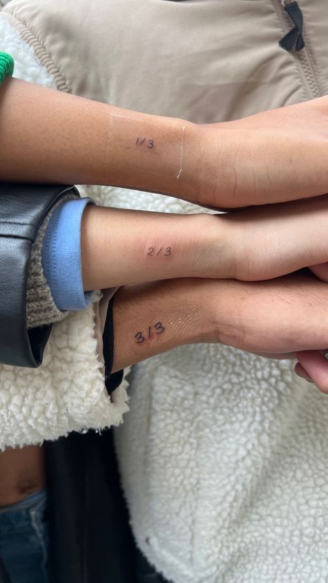 Three siblings wrist showcasing matching tiny tattoo Line Tattoos Family, Cute Matching Tattoos For Siblings, Tattoos To Get For Siblings, Two Siblings Tattoo, 3 Person Sibling Tattoo, Tattoo Ideas For Triplets, Tattoos For My Siblings, 3 Matching Tattoos Siblings, Matching Tattoos For 3 Cousins