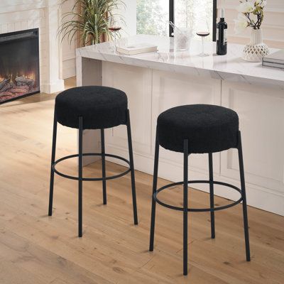 Casual with sleek lines, slide this pair of contemporary stools up to a bar or kitchen breakfast area. Designed with a thick pouf-like cushion wrapped in an on-trend boucle fabric, this stool lends an elegant playful charm to any space. The pouf-inspired seat rests nestled between an extension of the minimal style, and sleek modern frame. Metal frame with built-in footrest keeps your legs comfortable as you sip on that end-of-day rosé. Seat Height: Bar Stool (30” Seat Height), Seat Color/ Frame Boucle Bar Stool, Basement Furniture, Contemporary Stools, Color Frame, Metal Bar Stools, Boucle Fabric, Breakfast Area, Minimal Style, Counter Stool