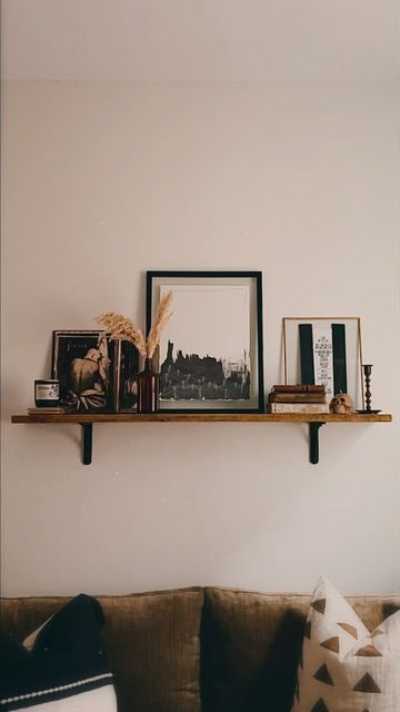 Wall Shelf Ideas Behind Couch, Over The Couch Shelf Decor, Shelf Decor Living Room Above Couch, Long Wood Shelf Above Couch, Floating Shelves Beside Tv, Floating Shelf Living Room Decor, Shelf Above Couch Decor, Photos On Shelves, Living Room Floating Shelves Above Couch