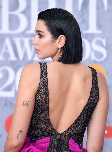 Dua Lipa Has Been Building Her Collection of Tiny Tattoos Since 2015 Tree Tattoo Finger, Dua Lipa Tattoo, Tattoos And Their Meanings, Thorn Tattoo, Palm Tattoos, Palm Tree Tattoo, Fire Tattoo, Bad Tattoos, Unique Tattoo Designs